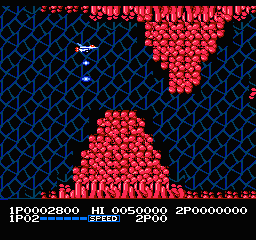 Life Force: the ship flies through a blue cavern past red organic walls, with the speed power-up meter at the bottom