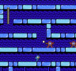 Mega Man 2: Mega Man stands on an icy blue ledge facing two orange robots, with the health bar at the left