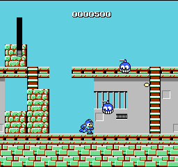 Mega Man: Mega Man on a brick floor in Cut Man's stage, with two blue flying robots and ladders overhead