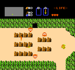 The Legend of Zelda: Link on the overworld among rocks, with Octoroks around him and three hearts of life